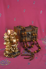 statue of Buddha, jewelry box, wooden beads