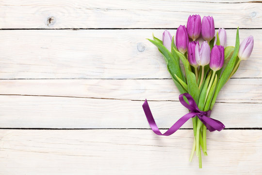 Fototapeta Purple tulips over wooden table