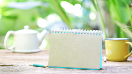Notebook and tea on wooden table