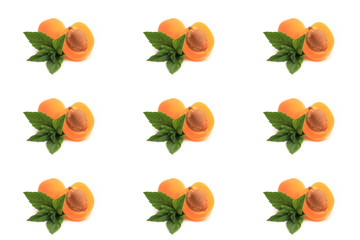 mint, apricot cut in half on white background