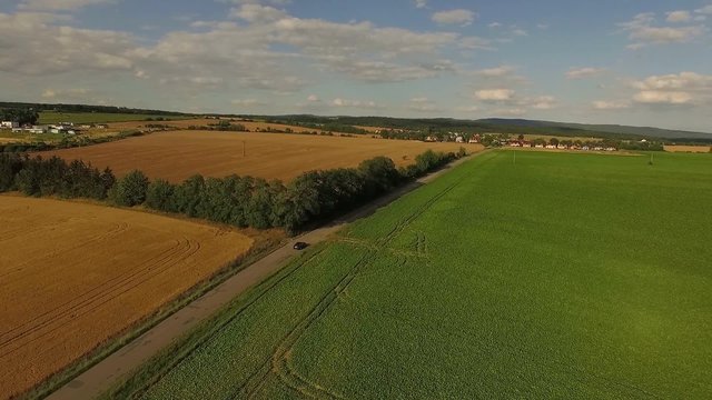 Aerial flight over rural landscapes of Central European countryside on a clear lovely summer day