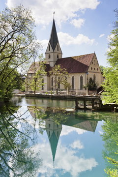 Church of Blaubeuren Monastry reflecting in Blautopf Spring, Blaubeuren, Swabian Alb, Baden Wurttemberg, Germany