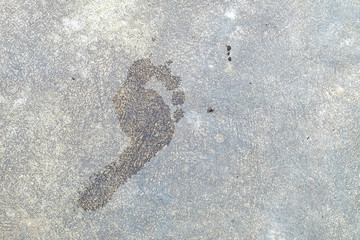 Wet floor of foot shape on cement background