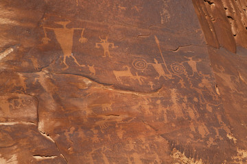 Pertoglyphs cared by Native Americans on rock face along the Colorado River.Near Moab,Utah