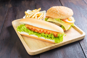 hamburger, hot dog, french fries on the wooden background