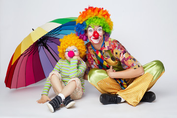 clown with colorful umbrella on white