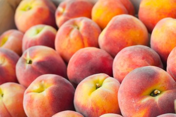 Fresh peach heap. Fruit background. Shallow DOF