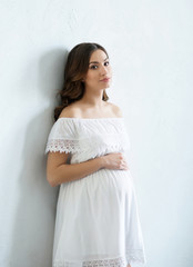 Beautiful pregnant woman on white background.