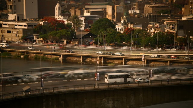 Time lapse of traffic in Cairo center just before sunset, the 15th May Bridge / 26th July Corridor in the foreground, the Corniche street in the background