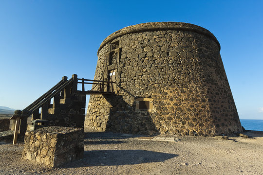 Old tower (toston), a defence against English pirates at this northwest coast village, El Cotillo, Fuerteventura, Canary Islands, Spain