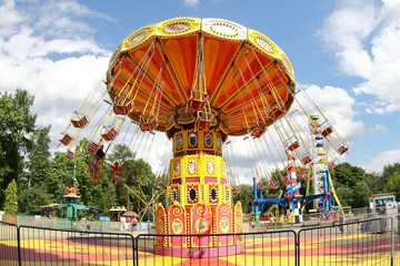 Orange carousel in an empty amusement park in late summer