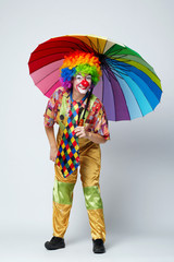 clown with colorful umbrella on white