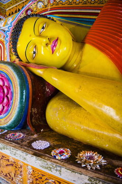 Colourful reclining Buddha statue at Isurumuniya Vihara, Anuradhapura, Sri Lanka,Asia