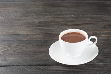 a cup of chocolate on wood table