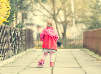 year-old girl riding her scooter