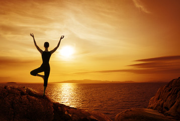 Fototapeta premium Yoga Meditation Concept, Woman Silhouette Meditating in Nature