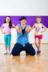 Fototapeta premium Dance teacher giving kids Zumba fitness class i