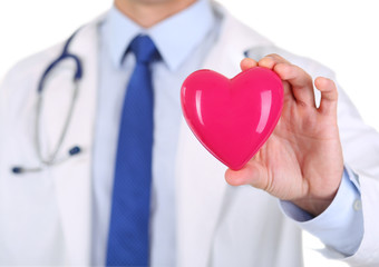 Male medicine doctor hands holding red toy heart