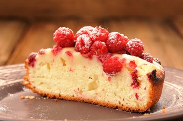 Homemade sponge cake with fresh juicy wild raspberries and icing
