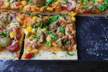 Homemade pie with sausage, olives, cheese, corn