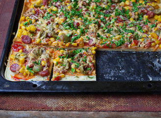 Homemade pie with sausage, olives, cheese, corn