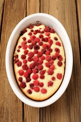 Homemade freshly baked sponge cake with wild raspberries in whit