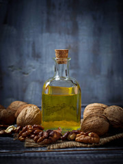 Walnut oil in bottle and nuts