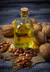 Obraz na płótnie Canvas Walnut oil in bottle and nuts