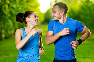 Runners training outdoors working out. City running couple