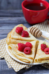 Sweet homemade crepes with raspberries