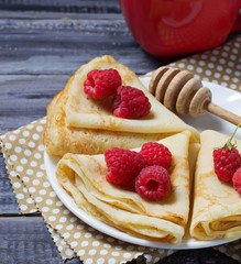 Sweet homemade crepes with raspberries