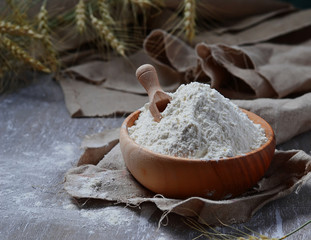Wheat flour in wooden bowl