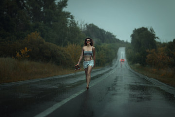 Girl walks barefoot on the roadway.