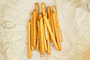 Breadsticks grissini on the paper surface