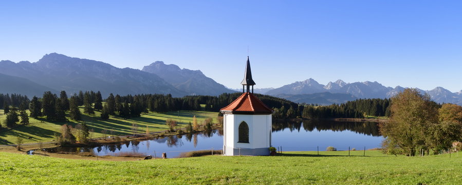 Chapel at Hergratsrieder See lake with Allgau Alps, near Fussen, Allgau, Ostallgau, Bavaria, Germany