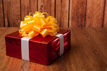 one large red gift box on a wood