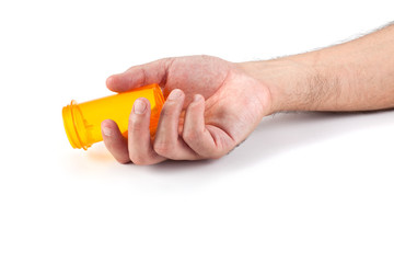 Man's hand with empty pill bottle