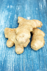 Fresh ginger root on wooden background