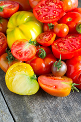 assorted tomatoes on wooden surface