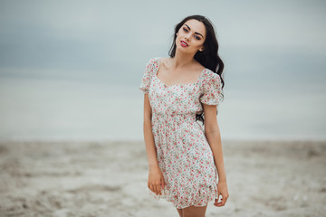  Beautiful and curly girl posing on a background of water