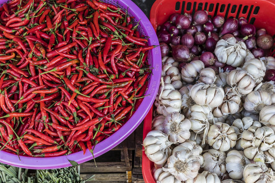 Red chillies, onions, and garlic for sale at fresh food market in Chau Doc, Mekong River Delta, Vietnam