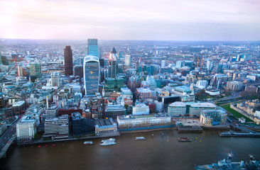 Fototapeta na wymiar LONDON, UK - APRIL 15, 2015: City of London panorama in sunset and first night lights.