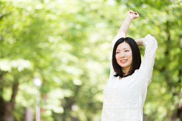 young asian woman relaxing in the park 