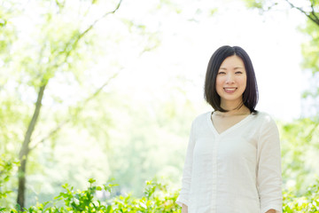 young asian woman relaxing in the park 