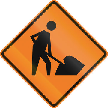Temporary warning road sign in Canada - Workers in road ahead. This sign is used in Ontario