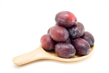 Fresh plums in wooden plate