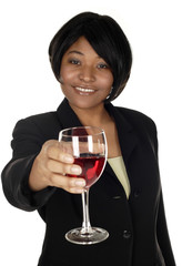 An attractive young woman toasts viewer wine. Focus is on her face.