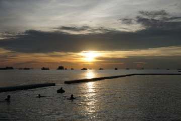 silhouette of the ships in the sea at the twilight time
