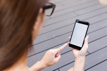 Woman using cellphone with blank screen