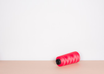 red sewing threads on clear background